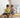 Two young children playing together on a wooden Montessori rocker in a cosy, light-filled kids’ room with natural furniture and a soft, calm atmosphere.